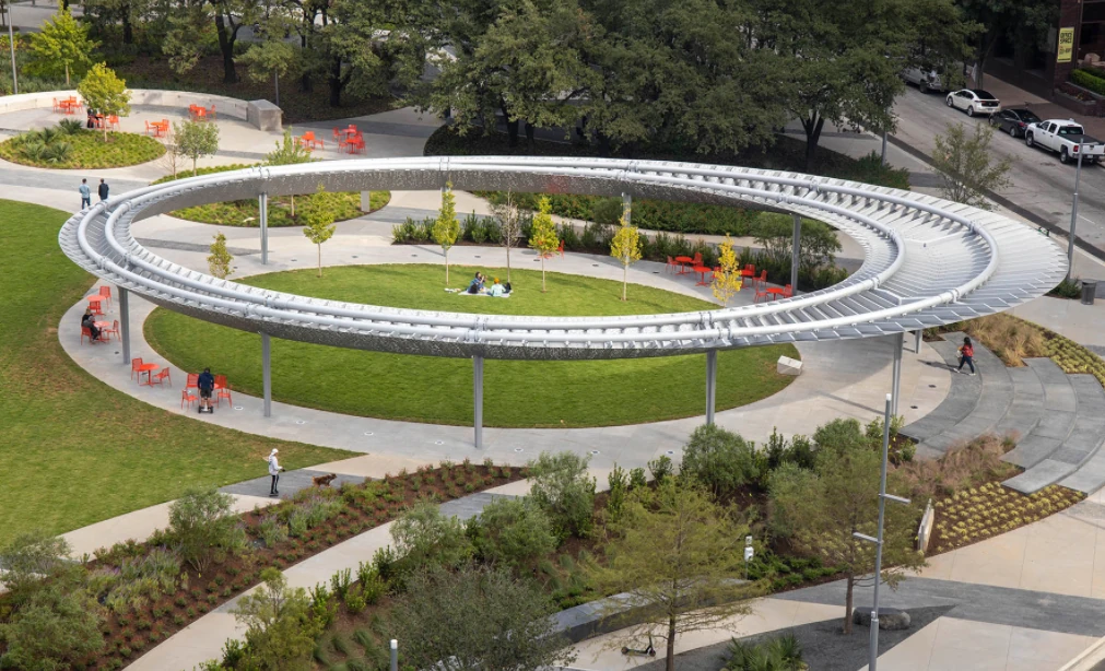 The pavilion: a raised ring on slender columns over a circle of lawn and seating